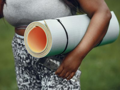 Close-up of a yoga mat and a water bottle in a calm setting.